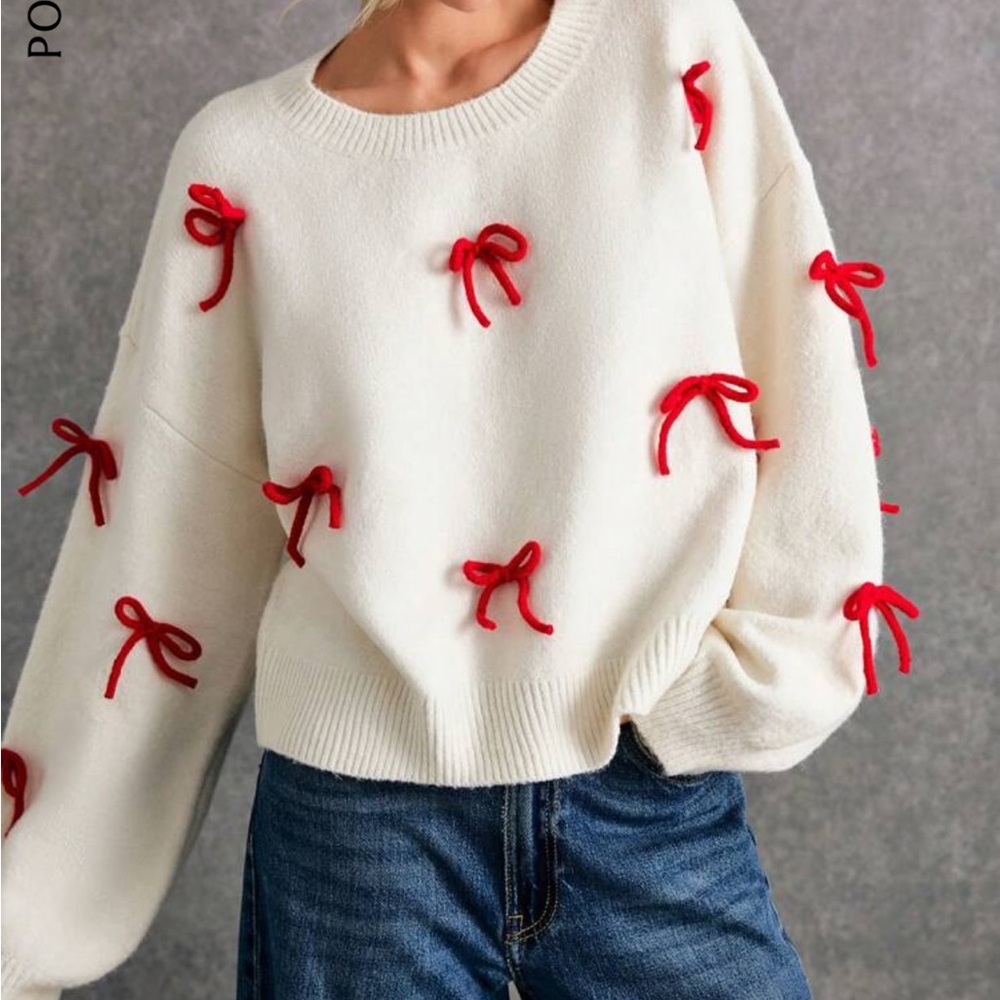 White oversized sweater with red bow accents medium